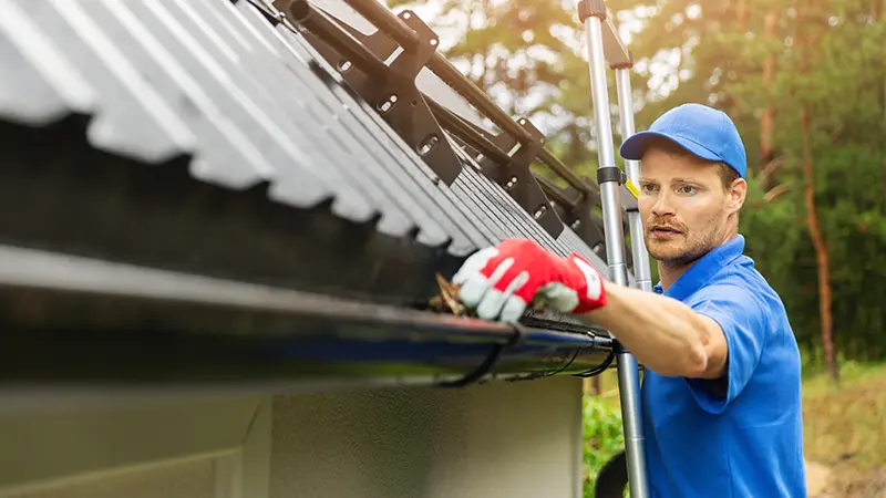A man cleaning gutters.