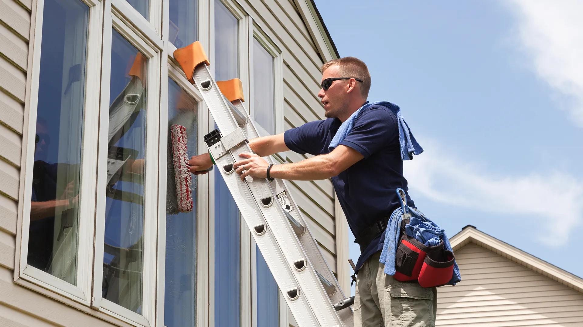 A man cleaning a window.