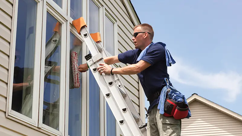 A man cleaning a window.