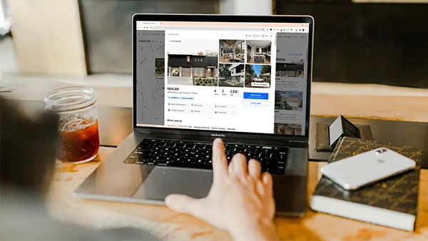 Person looking at an online home listing.