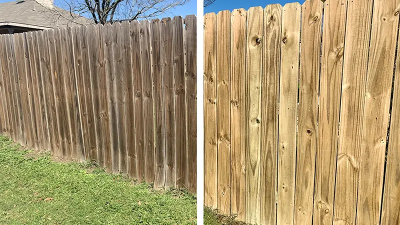 A fence that is half dirty and half clean.