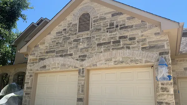 A dirty brick garage, before getting washed.