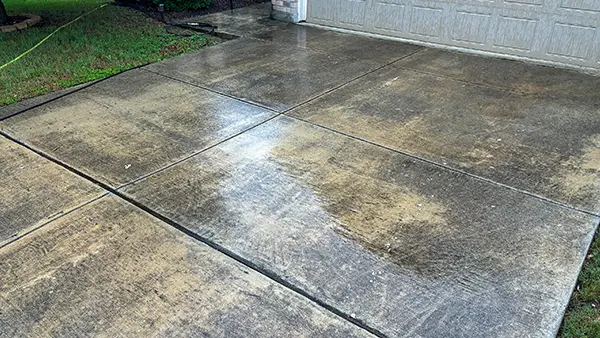 A dirty driveway before pressure washing.