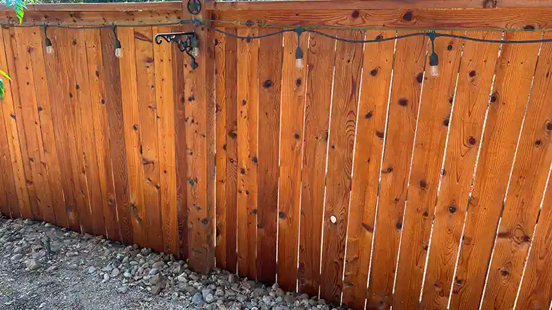 A wooden fence that has been stained.