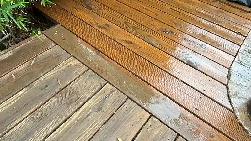 A half clean and half dirty wooden deck.