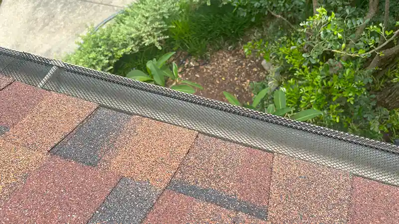 A gutter covered with gutter guards.