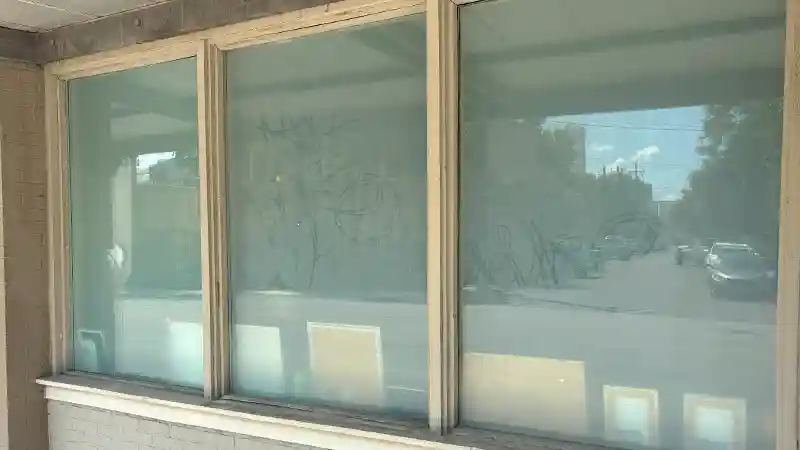 Three dirty windows covered in dust.