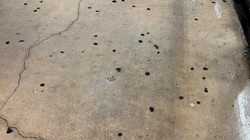 Gum stains covering a concrete surface.