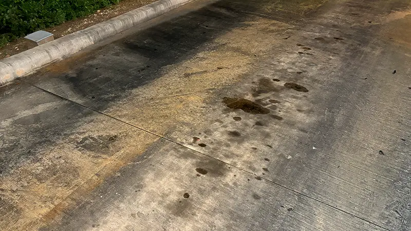 A drive-thru lane with rust and oil stains.