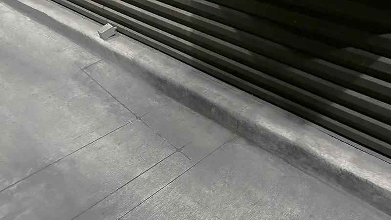 Clean concrete below a drive-thru window.