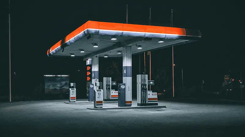 A gas station illuminated at night.