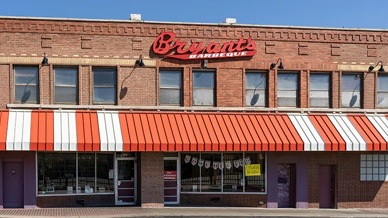 A restaurant with an orange awning.