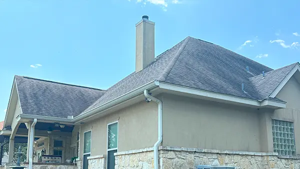 A steep shingle roof covered in black gloeocapsa magma, a type of bacteria.