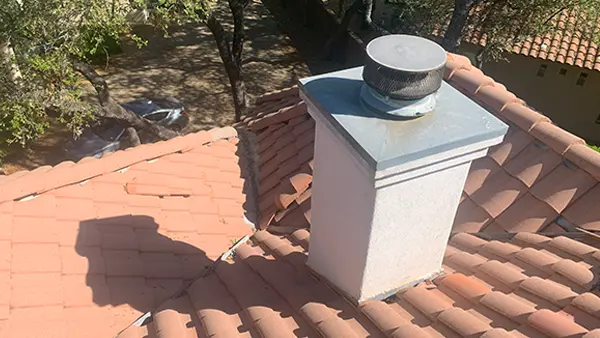 A complex tile roof with a chimney.