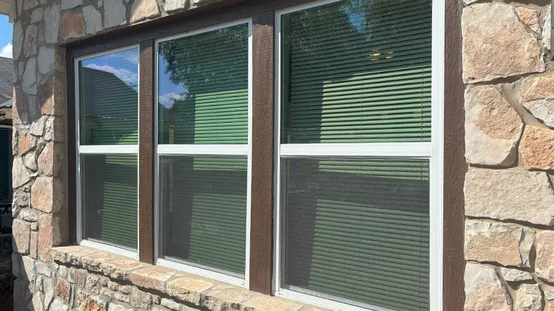Three windows with window screens.