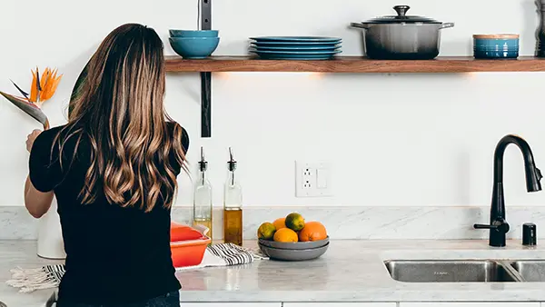 A woman organizing a kitchen.