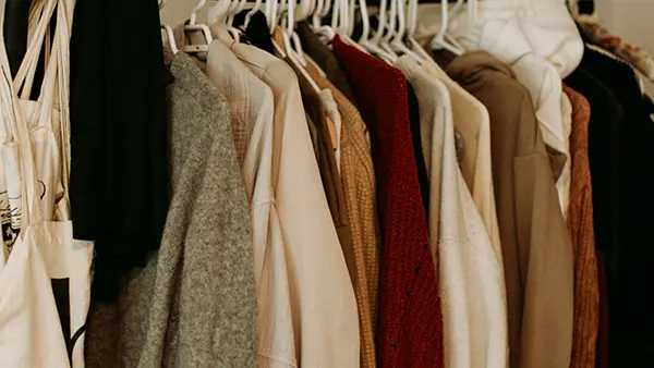 An organized closet full of clothing.