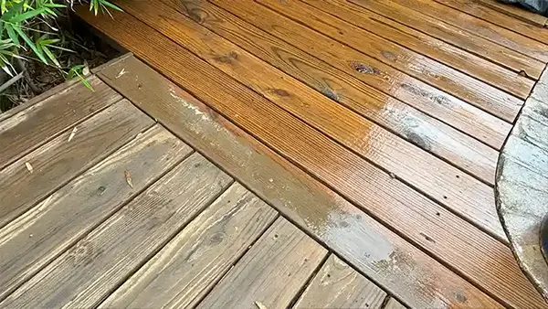 A wooden deck that's been partially washed.