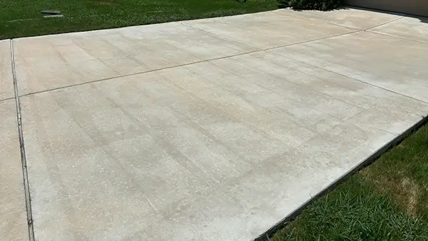 An etched driveway with cleaning stripes that need to be blended out.