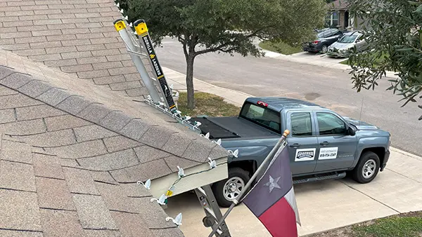 Christmas lights hung on a home's roofline.