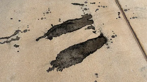 An oil stain on a driveway.