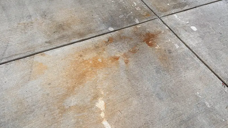 A concrete driveway with heavy rust stains.