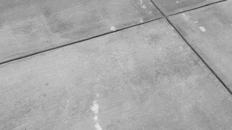 A clean concrete driveway with rust stains that have been removed.