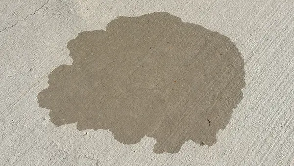 A San Antonio driveway that has not been sealed, causing it to absorb water.