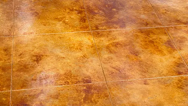 A decorative concrete patio in San Antonio that's been sealed with a glossy sealer.