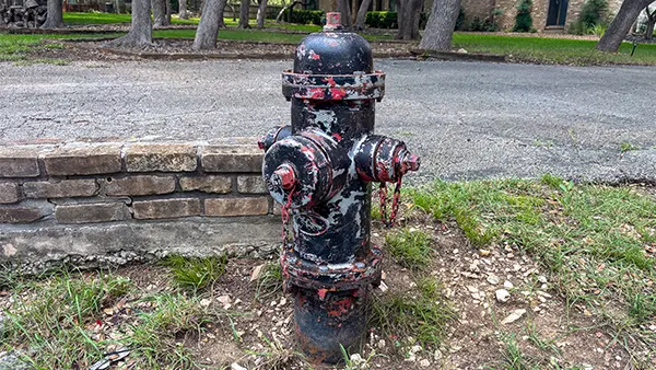 A corroded fire hydrant that's missing paint.